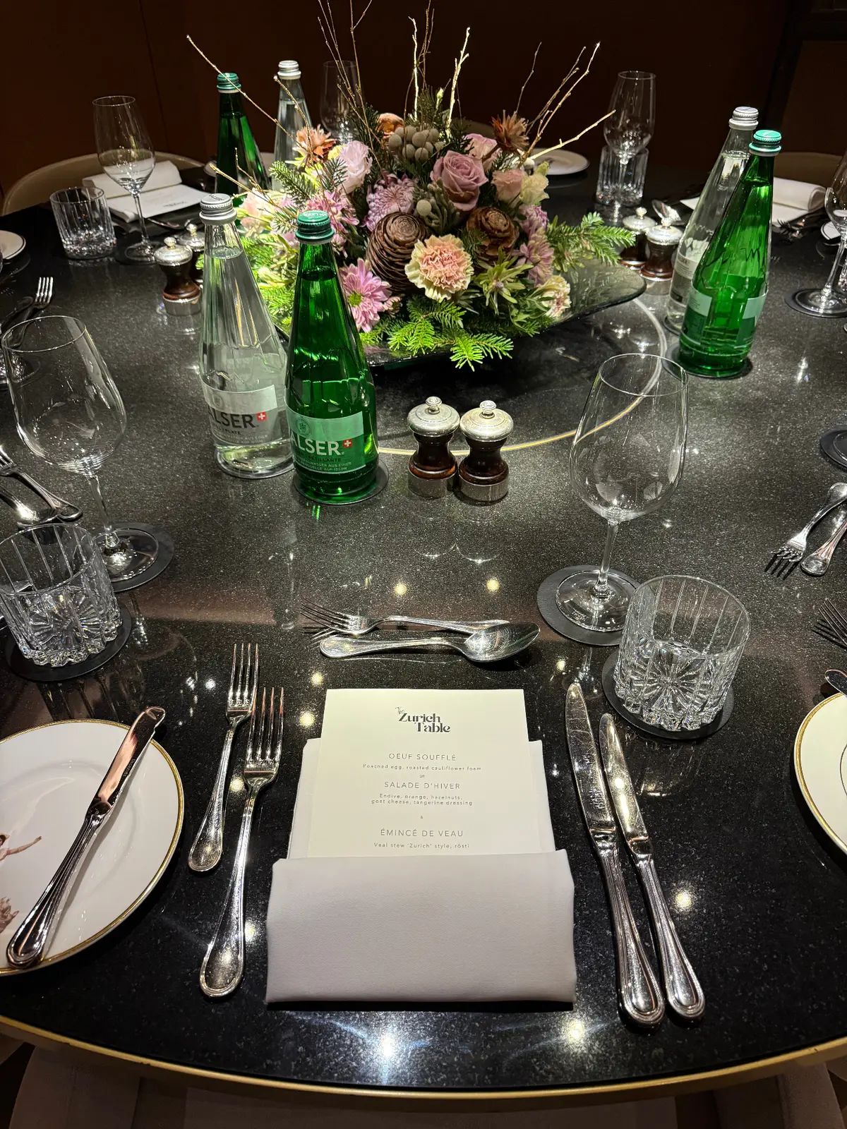 A Zurich Table place setting — crystal glassware and white florals